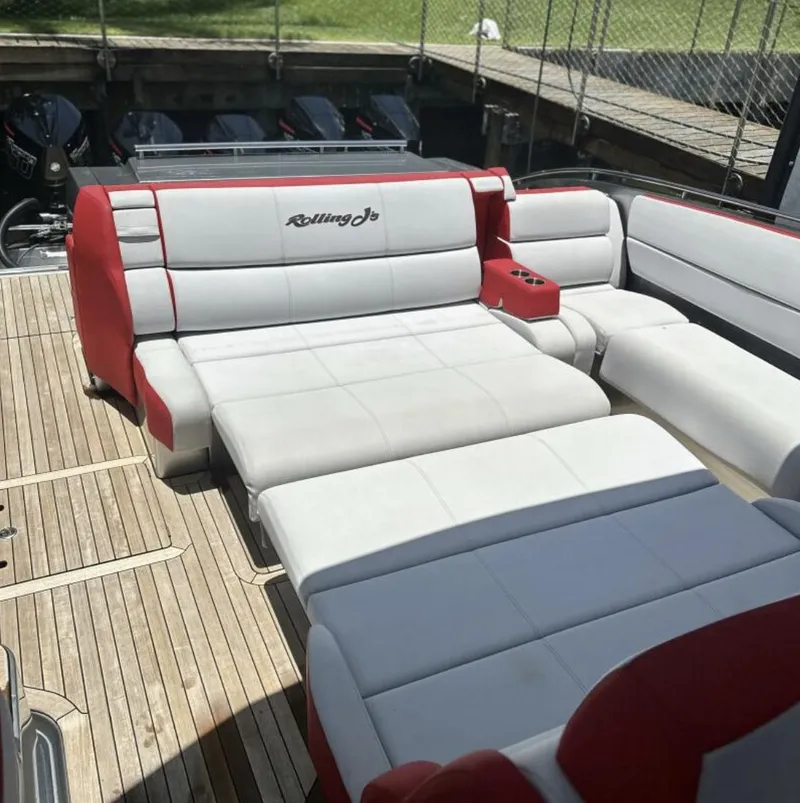 Slide: The Image of 2020 Cigarette 59 Tirranna boat with luxurious red and white seating on a wooden deck. - 8
