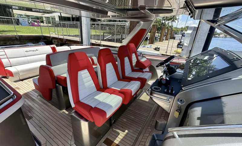 Slide: The Image of 2020 Cigarette 59 Tirranna boat interior with red and white seating, docked by the water. - 9