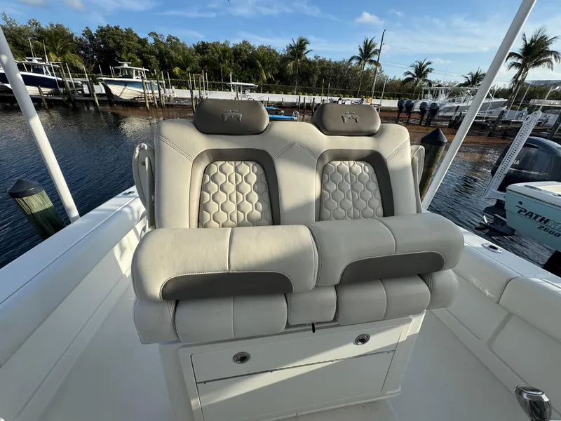 Slide: The Image of Luxury seating on 2018 World Cat 280 CC-X boat, docked by palm trees. - 11