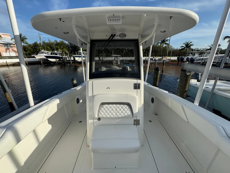 Slide: The Image of 2018 World Cat 280 CC-X boat with spacious deck and seating, docked at marina. - 12