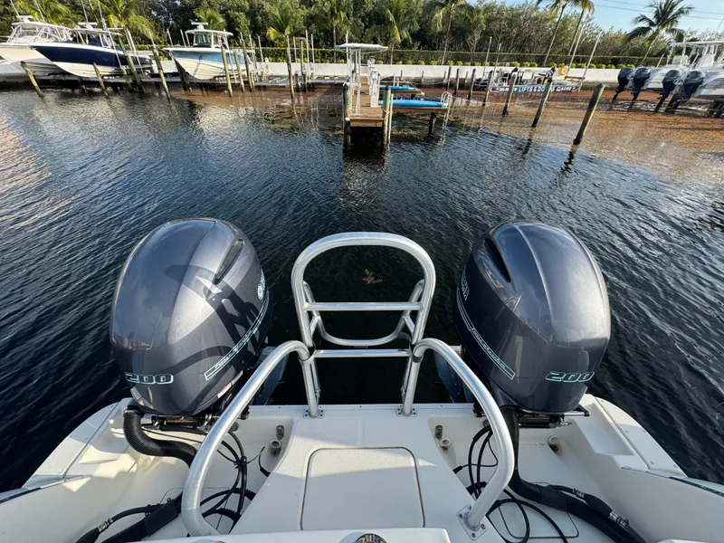 Slide: The Image of 2018 World Cat 280 CC-X boat with dual engines docked at a marina. - 16