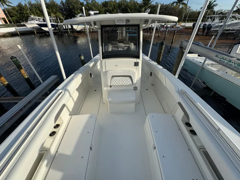 Slide: The Image of 2018 World Cat 280 CC-X boat with spacious deck and seating, docked at marina. - 17