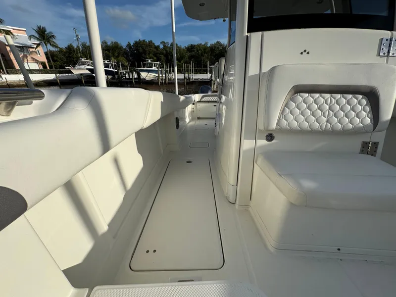 Slide: The Image of 2018 World Cat 280 CC-X boat interior with white seating and storage compartments. - 19