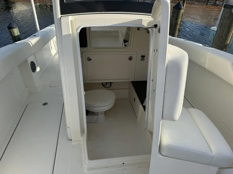 Slide: The Image of 2018 World Cat 280 CC-X boat interior with a compact marine toilet. - 21