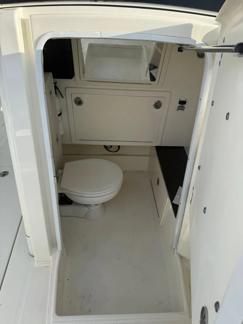 Slide: The Image of 2018 World Cat 280 CC-X boat interior with toilet and storage. - 22