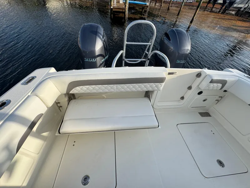 Slide: The Image of 2018 World Cat 280 CC-X boat interior with dual engines and seating area. - 23