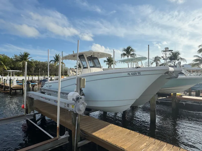 Slide: The Image of 2018 World Cat 280 CC-X boat docked at marina under blue sky. - 3