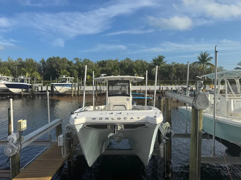 Slide: The Image of 2018 World Cat 280 CC-X boat docked at marina under clear blue sky. - 4