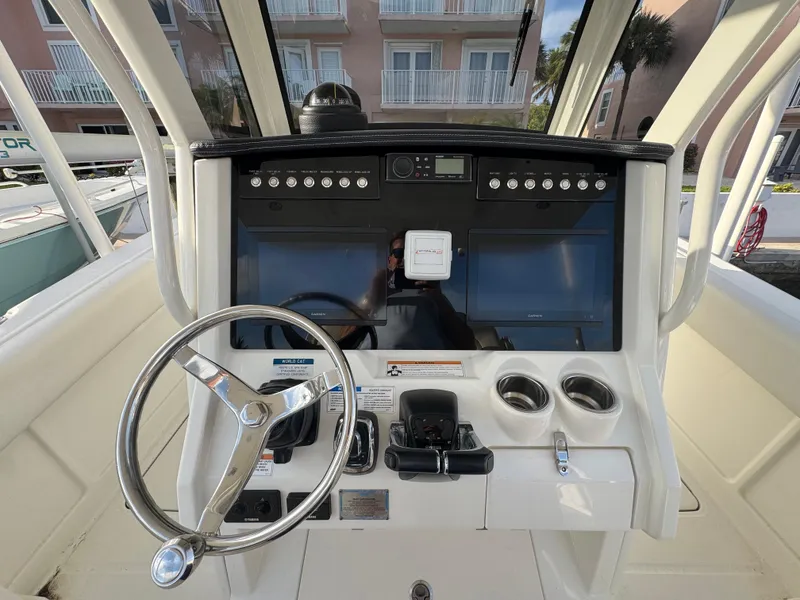 Slide: The Image of 2018 World Cat 280 CC-X boat dashboard with steering wheel and control panel. - 6
