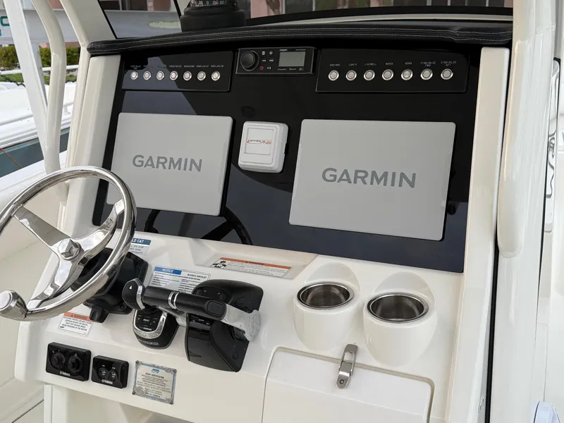 Slide: The Image of Control panel of 2018 World Cat 280 CC-X with Garmin displays and steering wheel. - 7