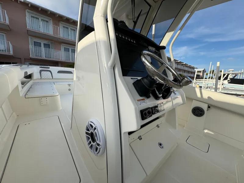 Slide: The Image of 2018 World Cat 280 CC-X boat interior with steering wheel and control panel. - 9