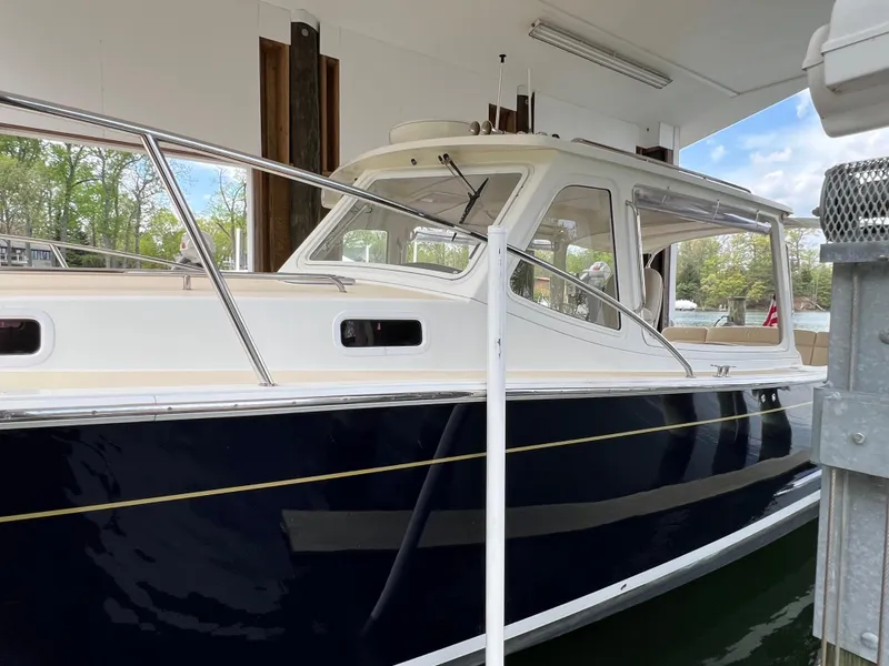 Slide: The Image of 2011 MJM 36Z boat docked in a covered marina, side view. - 11