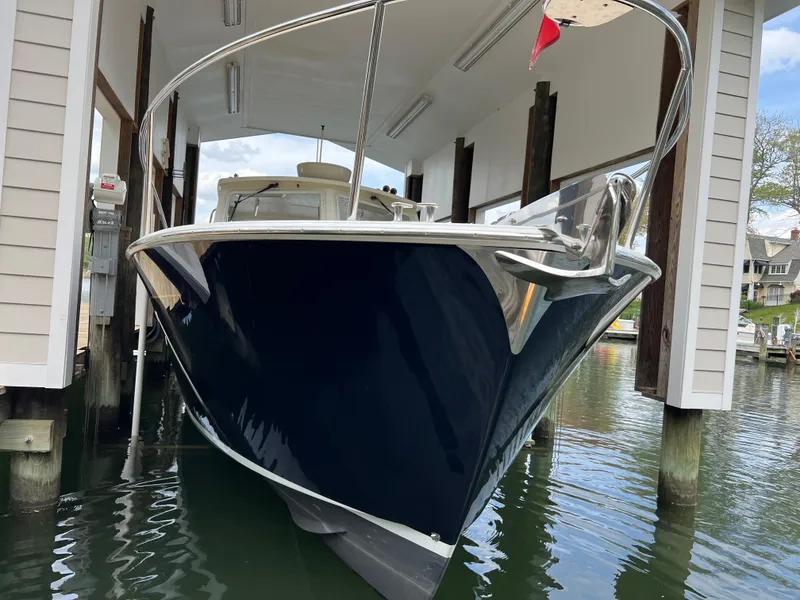 Slide: The Image of 2011 MJM 36Z boat docked in a covered marina, front view. - 12