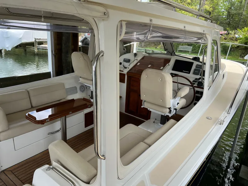 Slide: The Image of 2011 MJM 36Z yacht interior with helm, seating, and wooden accents. - 15