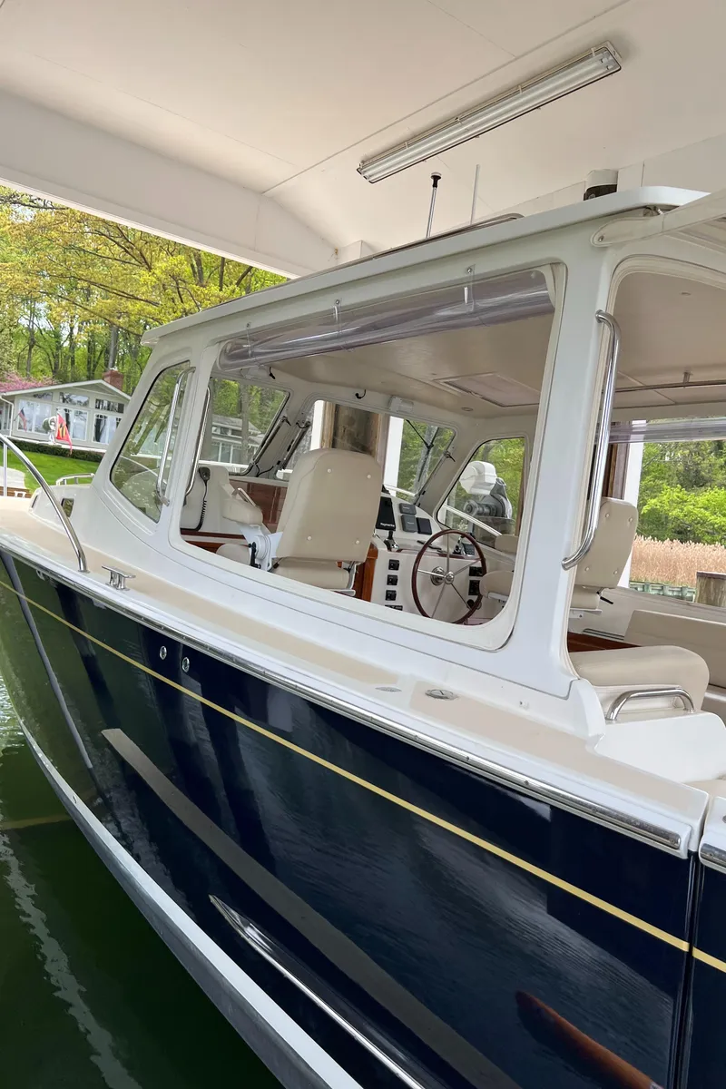 Slide: The Image of 2011 MJM 36Z boat docked under a covered area, showcasing sleek design and modern features. - 22