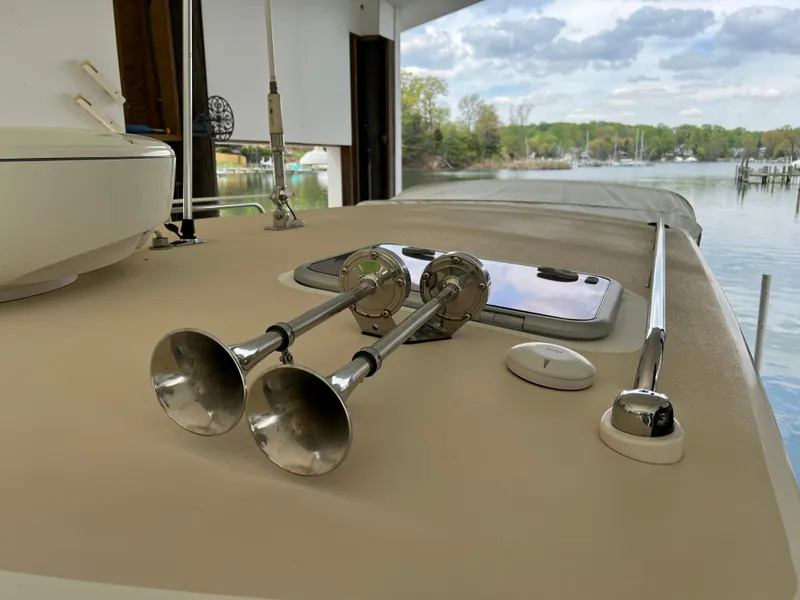 Slide: The Image of 2011 MJM 36Z yacht deck with dual horns, docked by a scenic waterfront. - 24