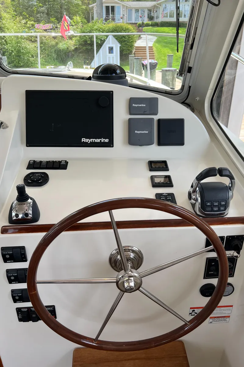 Slide: The Image of 2011 MJM 36Z helm with Raymarine electronics and wooden steering wheel. - 25