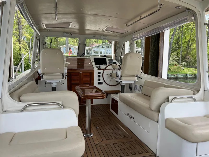 Slide: The Image of Interior of a 2011 MJM 36Z boat with beige seating and wooden accents. - 33