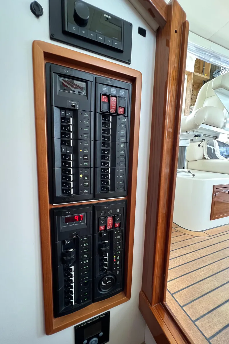 Slide: The Image of Control panel on a 2011 MJM 36Z boat, featuring switches and circuit breakers. - 35