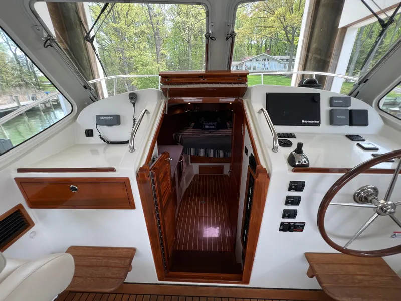 Slide: The Image of Interior view of 2011 MJM 36Z boat cockpit with wooden accents and navigation equipment. - 37