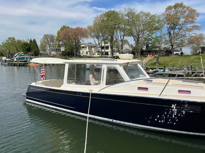 Slide: The Image of 2011 MJM 36Z boat docked in a scenic waterfront setting. - 7