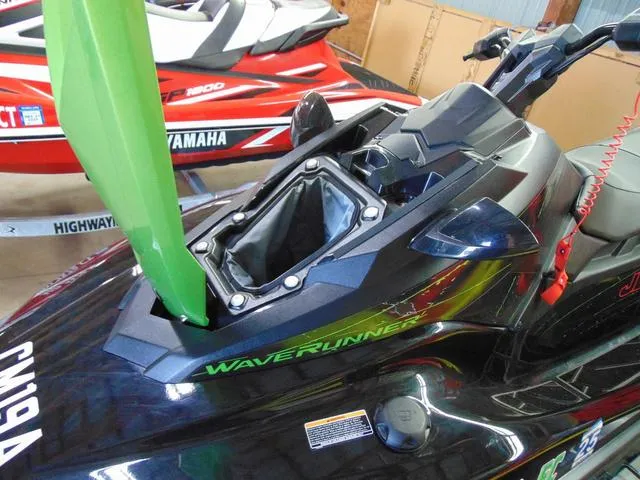 Slide: The Image of 2023 Yamaha Waverunner Jetblaster with open storage compartment, black and green design. - 15