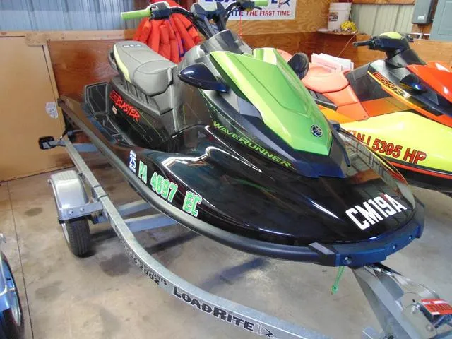 Slide: The Image of 2023 Yamaha Waverunner Jetblaster on trailer, green and black design, indoor display. - 3