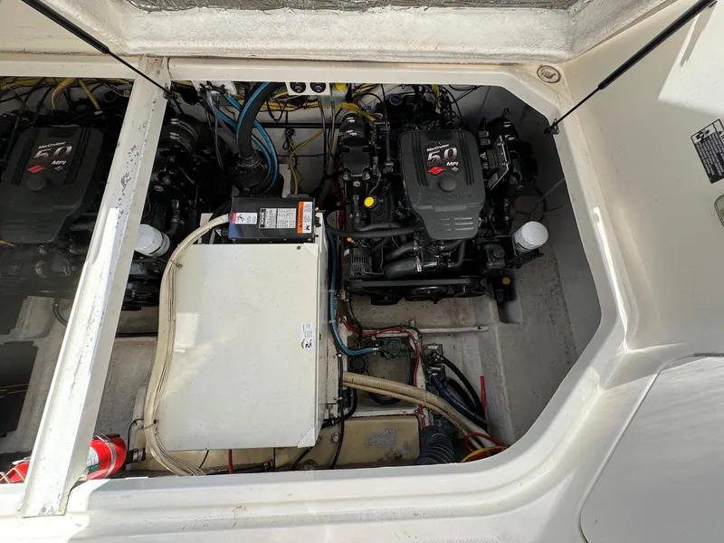 Slide: The Image of Engine compartment of a 2006 Bayliner 305 boat, showcasing dual engines and wiring. - 16