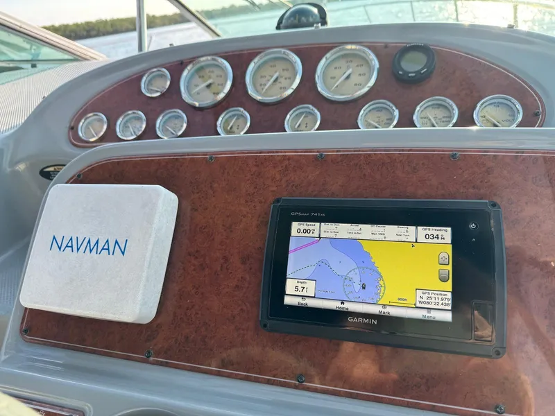 Slide: The Image of Dashboard of a 2006 Bayliner 305 boat with navigation instruments and GPS display. - 7
