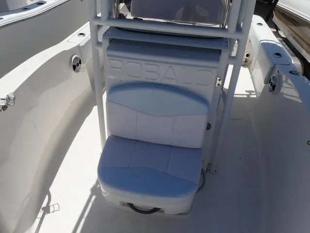 Slide: The Image of 2018 Robalo R180 boat interior with cushioned seating and console. - 11