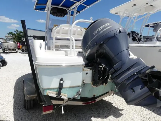 Slide: The Image of 2018 Robalo R180 boat with Yamaha outboard motor, parked on gravel. - 4