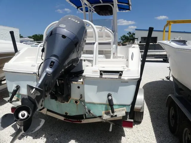 Slide: The Image of 2018 Robalo R180 boat with outboard motor, parked on a trailer in a sunny marina. - 5