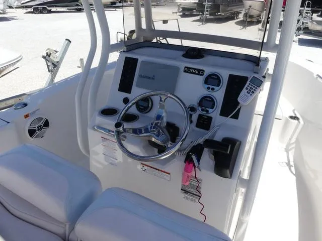 Slide: The Image of 2018 Robalo R180 boat console with steering wheel and navigation controls. - 6