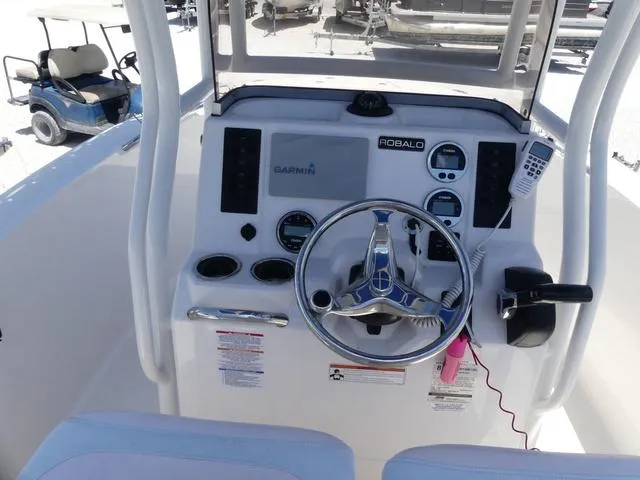 Slide: The Image of 2018 Robalo R180 boat dashboard with steering wheel and navigation controls. - 7