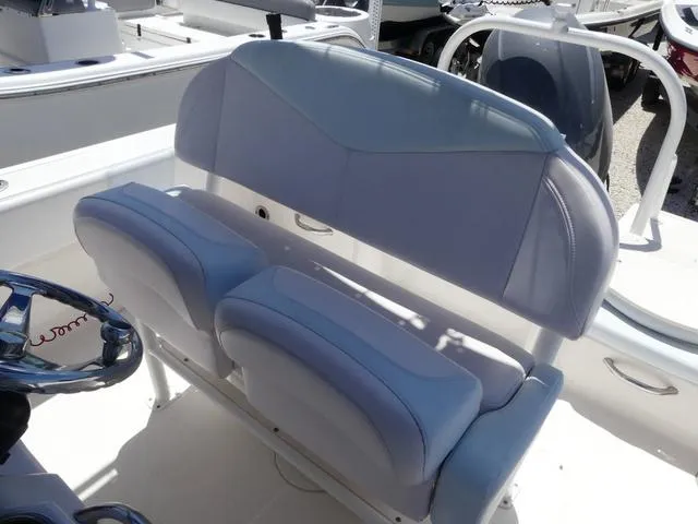 Slide: The Image of 2018 Robalo R180 boat seating with cushioned dual seats and steering wheel. - 8