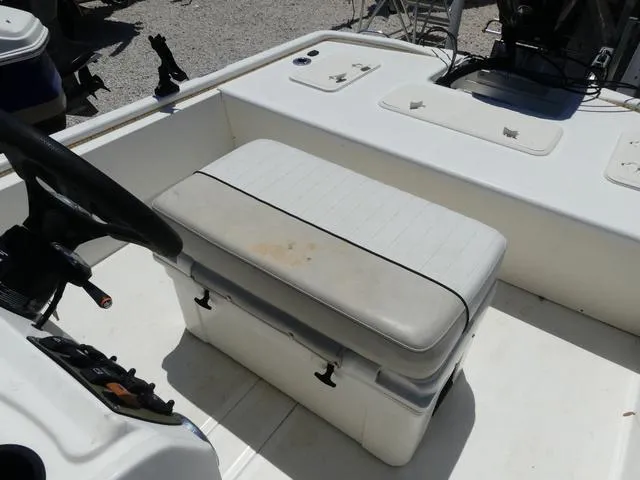 Slide: The Image of 2016 Mako Pro 17 Skiff CC boat interior with cushioned seating and steering console. - 10