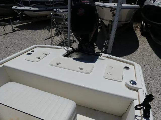 Slide: The Image of 2016 Mako Pro 17 Skiff CC boat, rear view with motor and seating area. - 11