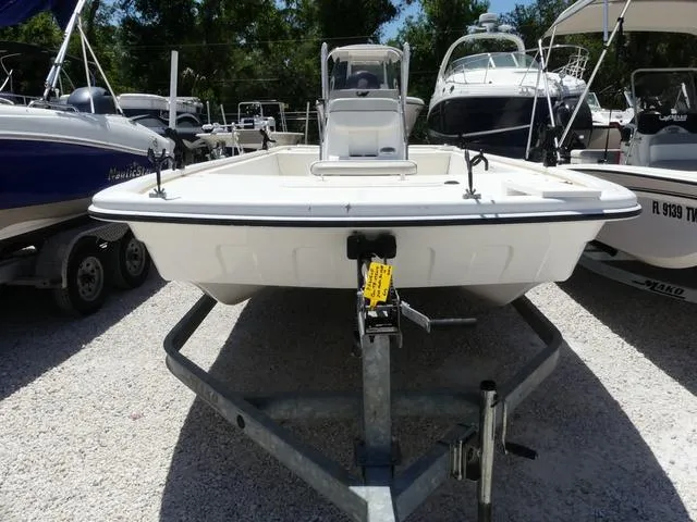 Slide: The Image of 2016 Mako Pro 17 Skiff CC boat on trailer, parked among other boats. - 2