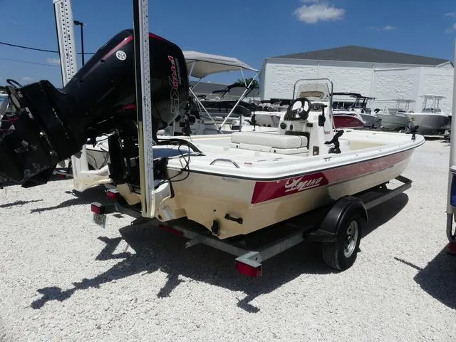 Slide: The Image of 2016 Mako Pro 17 Skiff CC boat on trailer, displayed outdoors under clear sky. - 4