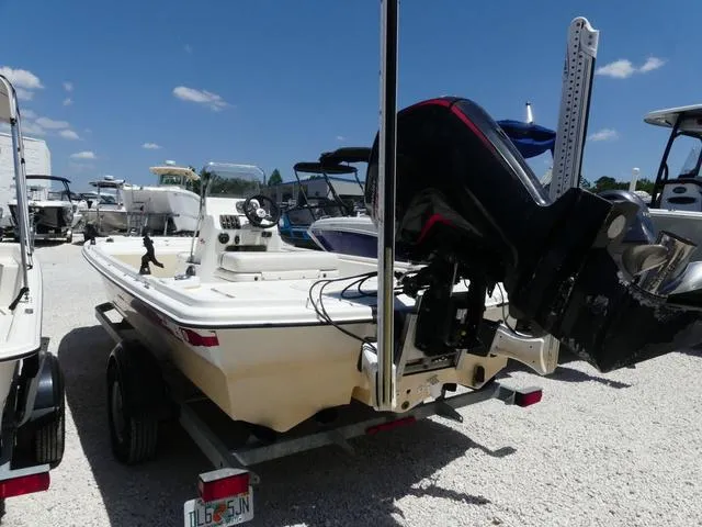 Slide: The Image of 2016 Mako Pro 17 Skiff CC boat on trailer, parked in a marina under clear blue sky. - 5