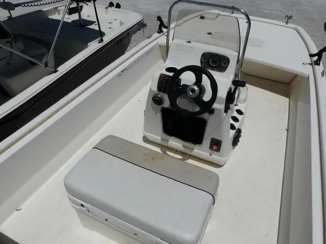 Slide: The Image of 2016 Mako Pro 17 Skiff CC boat interior with steering console and seating. - 7