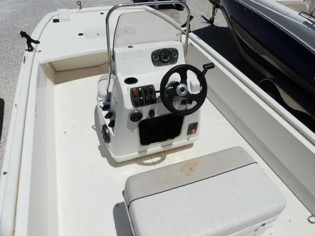 Slide: The Image of 2016 Mako Pro 17 Skiff CC boat interior with steering console and seating. - 9