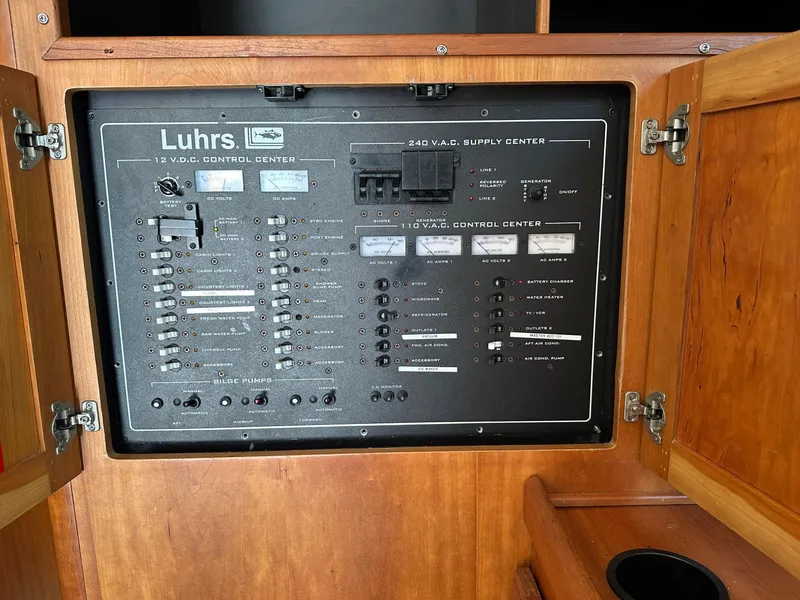 Slide: The Image of Control panel of 2003 Luhrs 40 Convertible boat, featuring electrical switches and indicators. - 13