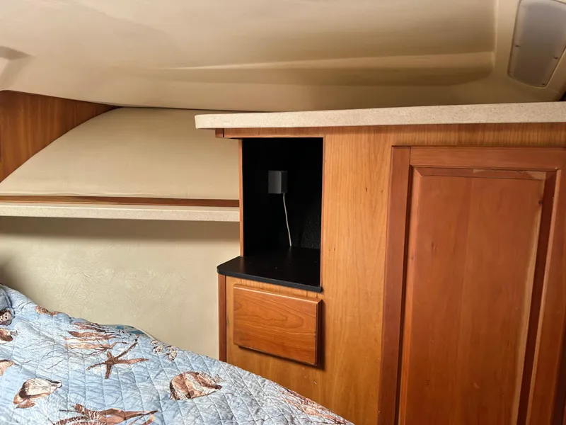 Slide: The Image of 2003 Luhrs 40 Convertible cabin interior with wood cabinetry and bed. - 14