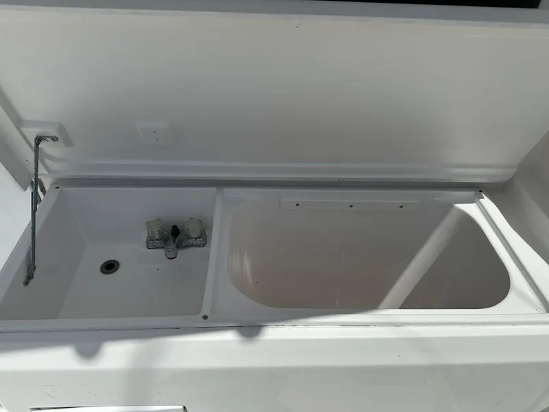 Slide: The Image of 2003 Luhrs 40 Convertible boat sink and storage compartment. - 21