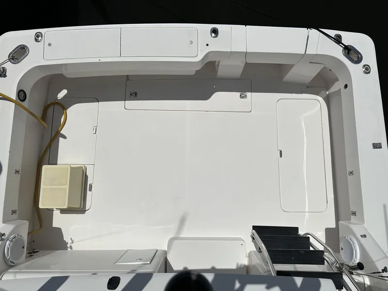 Slide: The Image of 2003 Luhrs 40 Convertible boat deck, featuring spacious layout and storage compartments. - 22