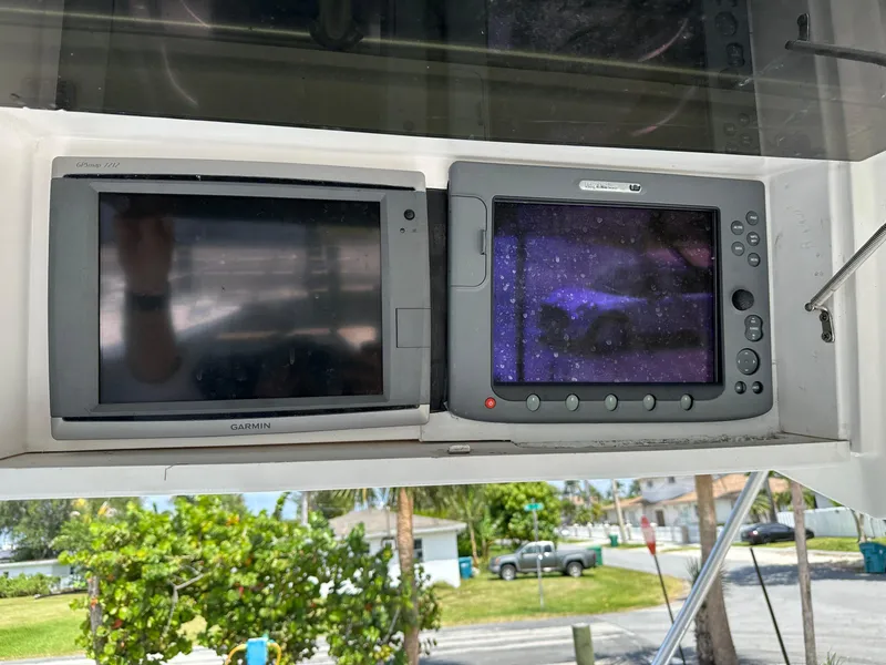 Slide: The Image of 2003 Luhrs 40 Convertible boat electronics, featuring Garmin and Raymarine displays. - 3