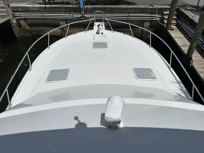 Slide: The Image of 2003 Luhrs 40 Convertible boat deck, white surface, docked in marina. - 32