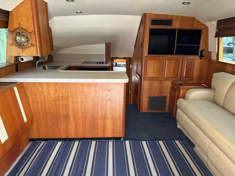Slide: The Image of Interior of 2003 Luhrs 40 Convertible yacht with wood cabinetry and striped carpet. - 5