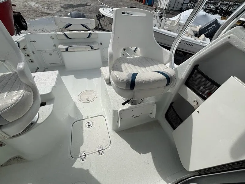 Slide: The Image of 2005 Polar 2300 boat interior with white seating and storage compartments. - 10
